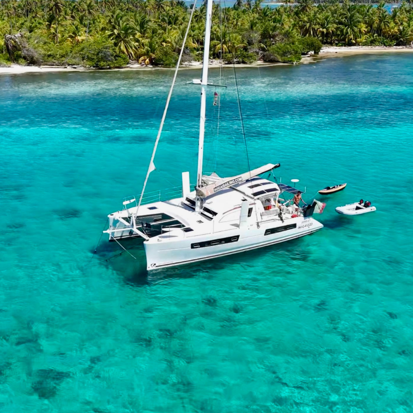 Catana 47 catamaran sailing through the crystal-clear waters of the San Blas Islands, Panama.