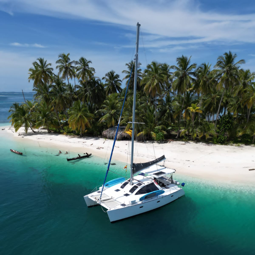 Lagoon 37 Catamaran sailing through the crystal-clear waters of the San Blas Islands, Panama.