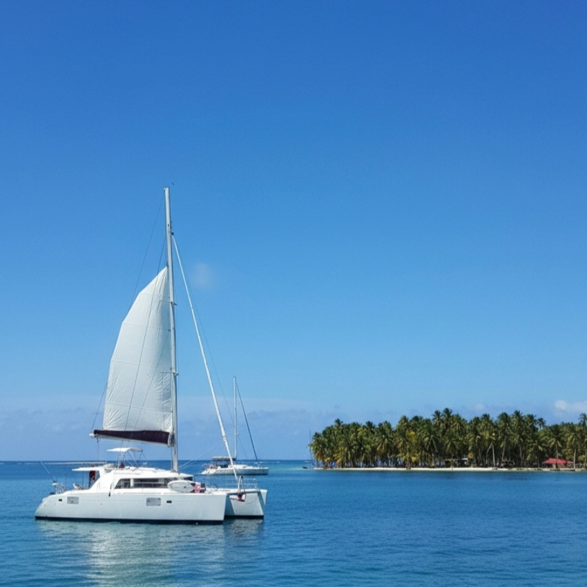 Lagoon 44 Catamaran sailing through the crystal-clear waters of the San Blas Islands, Panama.