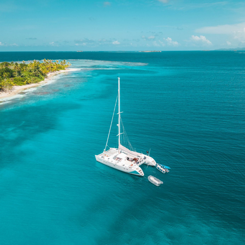 Lagoon 47 Catamaran sailing through the crystal-clear waters of the San Blas Islands, Panama.