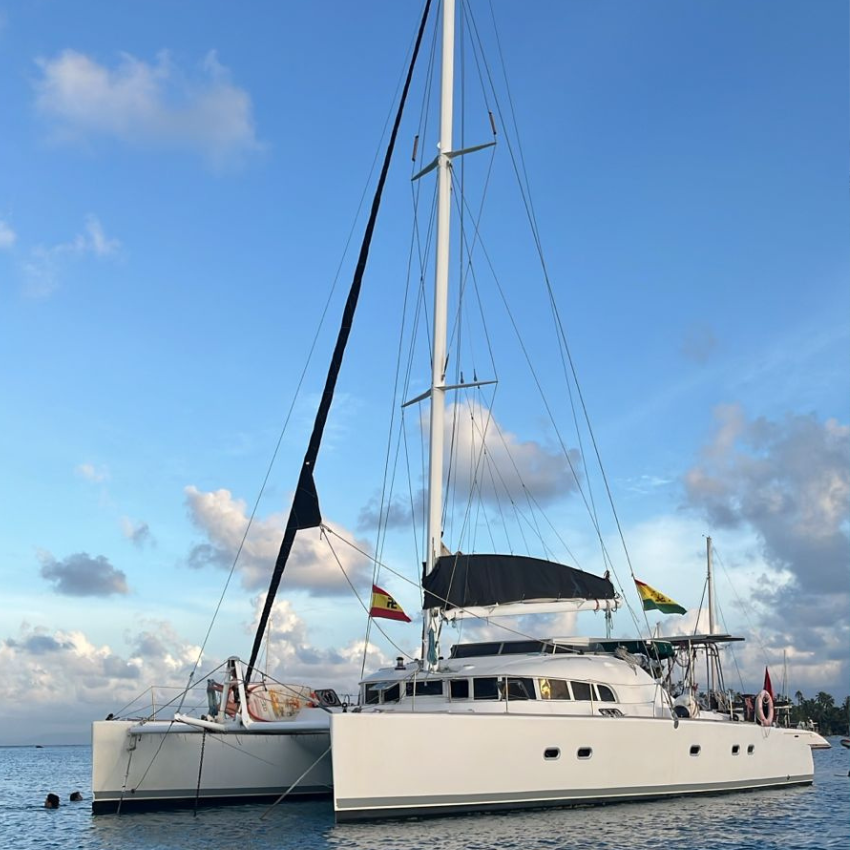 Lagoon 52 catamaran sailing through the crystal-clear waters of the San Blas Islands, Panama.